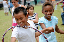 Niño y niña juegan con un hula hula